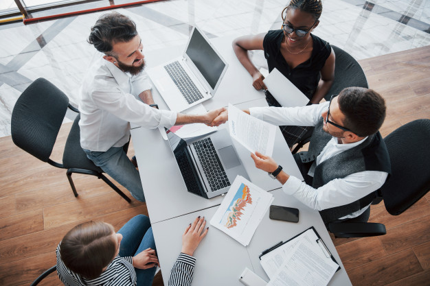 young-employees-sitting-office-table-using-laptop-team-work-brainstorming-meeting-concept_146671-15628